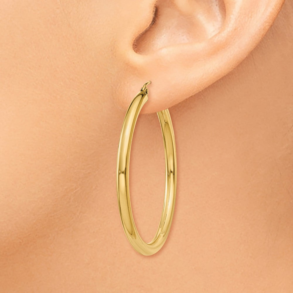 Alternate view of the 3mm x 40mm 14k Yellow Gold Classic Round Hoop Earrings by The Black Bow Jewelry Co.