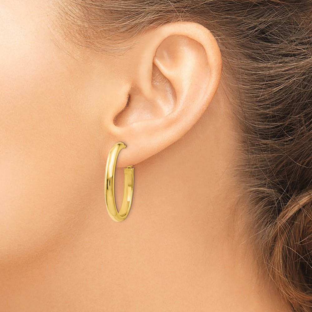 Alternate view of the 4mm Omega Back Oval Hoop Earrings in 14k Yellow Gold, 30mm by The Black Bow Jewelry Co.