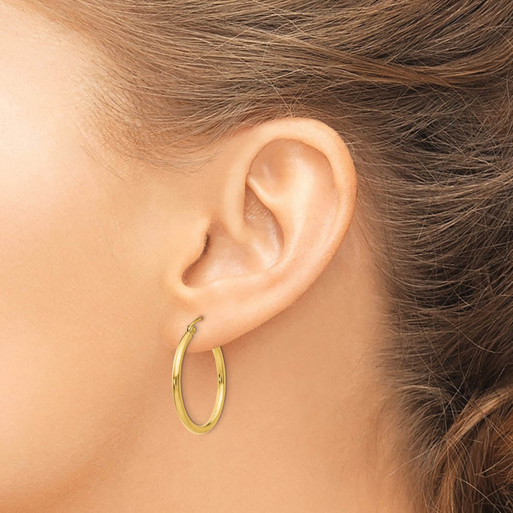 Alternate view of the 2mm x 25mm 14k Yellow Gold Classic Round Hoop Earrings by The Black Bow Jewelry Co.
