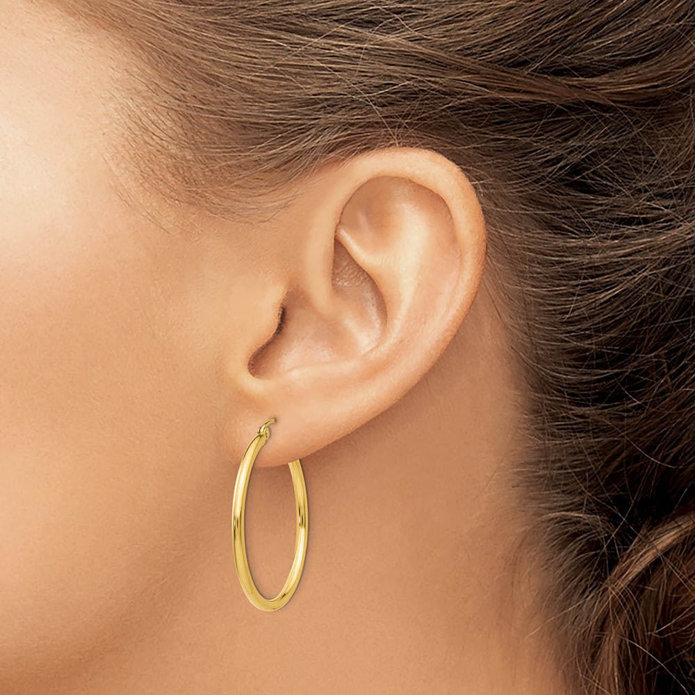 Alternate view of the 2mm x 30mm 14k Yellow Gold Classic Round Hoop Earrings by The Black Bow Jewelry Co.