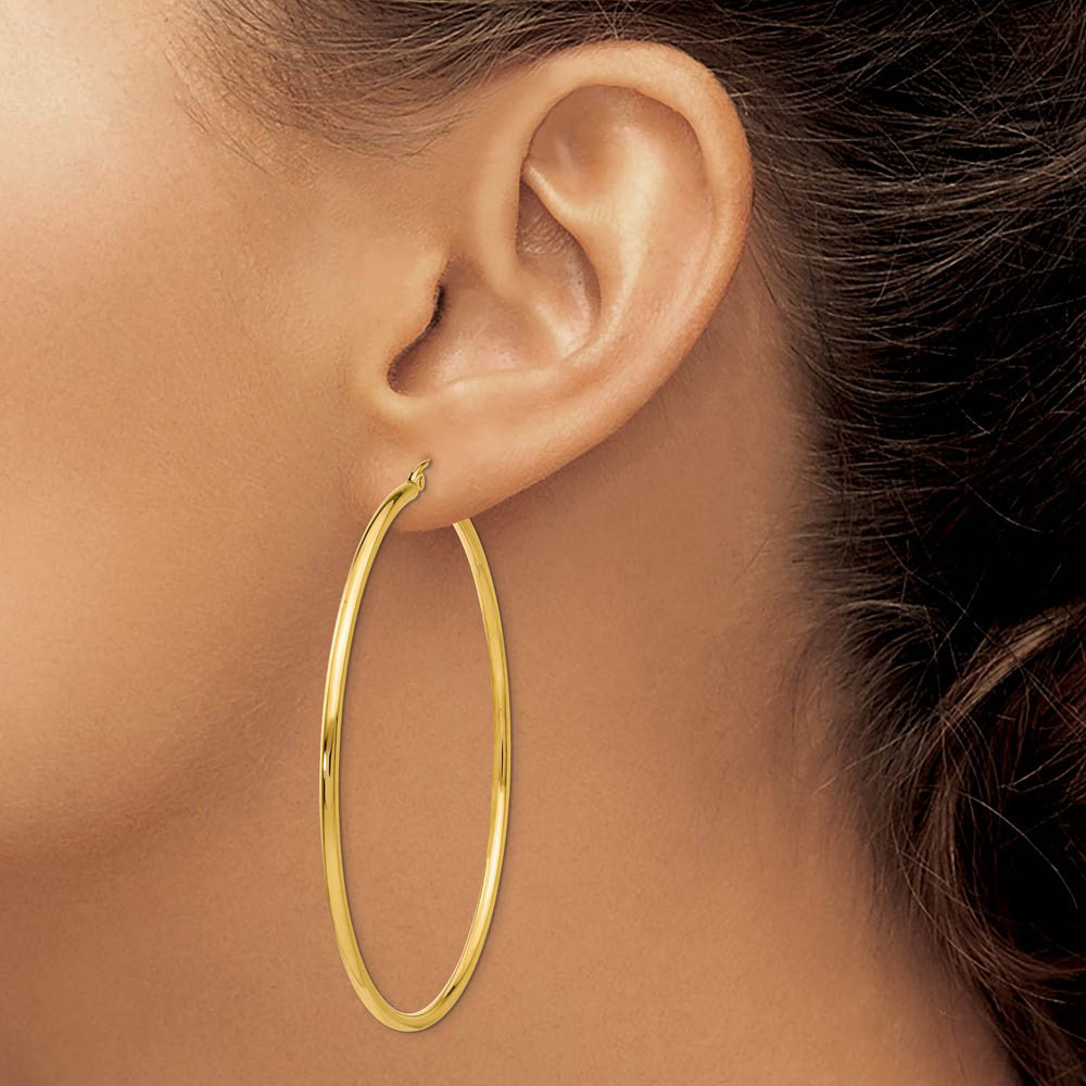 Alternate view of the 2mm x 60mm 14k Yellow Gold Classic Round Hoop Earrings by The Black Bow Jewelry Co.