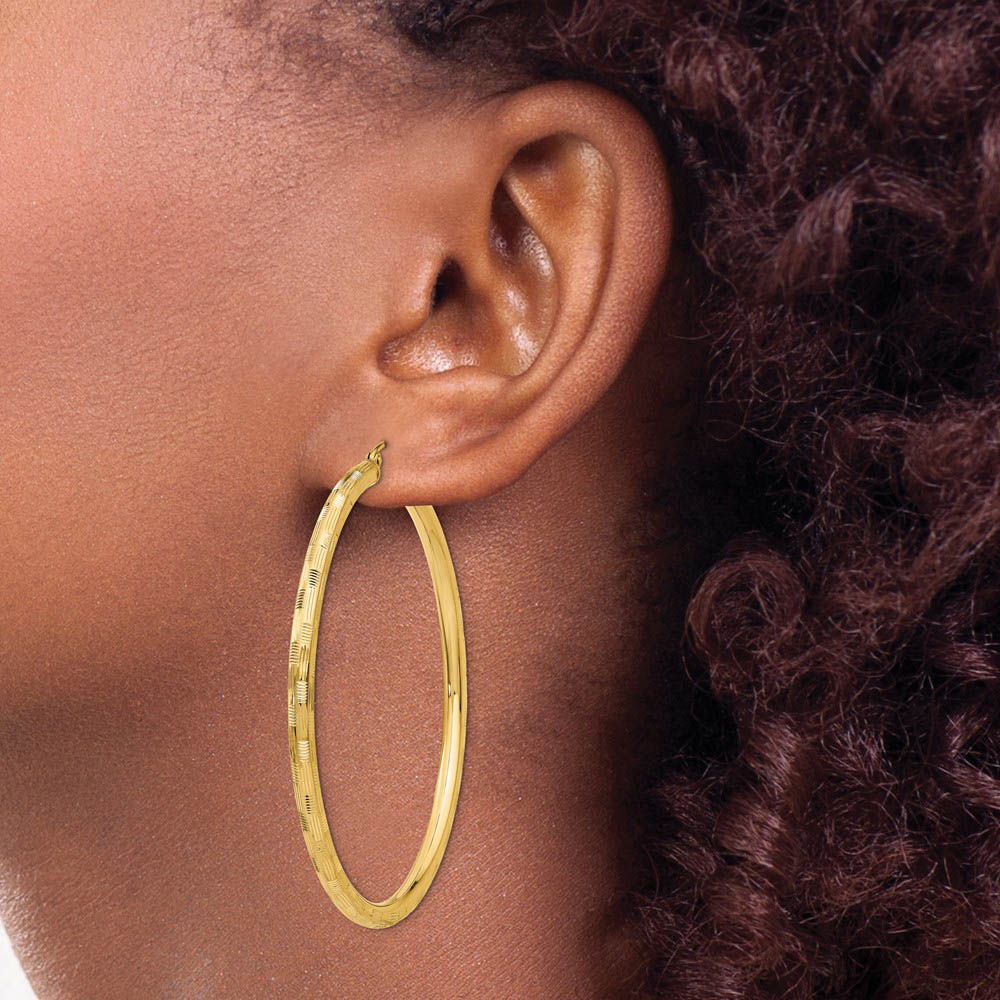 Alternate view of the 3mm x 55mm 14k Yellow Gold Textured Round Hoop Earrings by The Black Bow Jewelry Co.