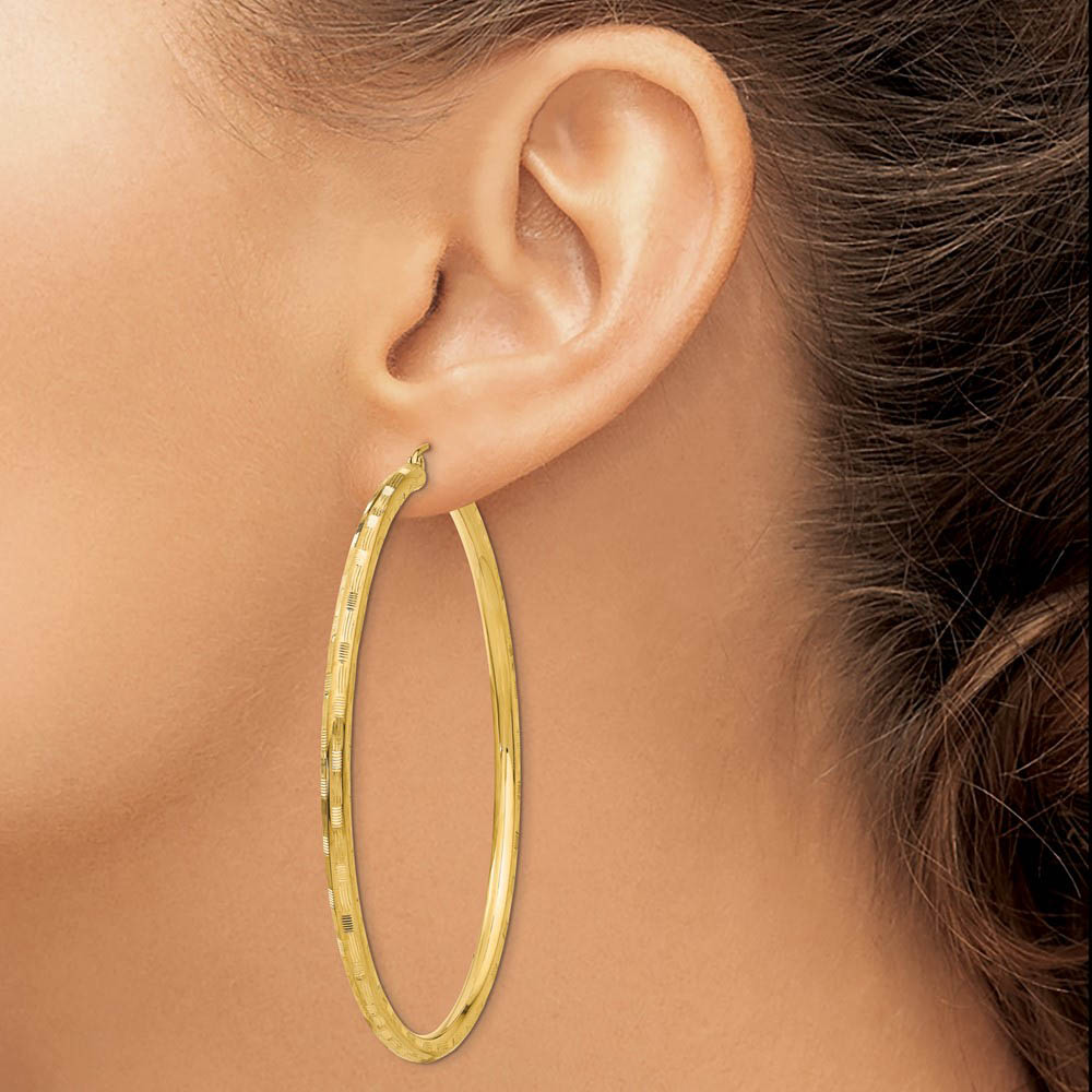 Alternate view of the 3mm x 65mm 14k Yellow Gold Textured Round Hoop Earrings by The Black Bow Jewelry Co.