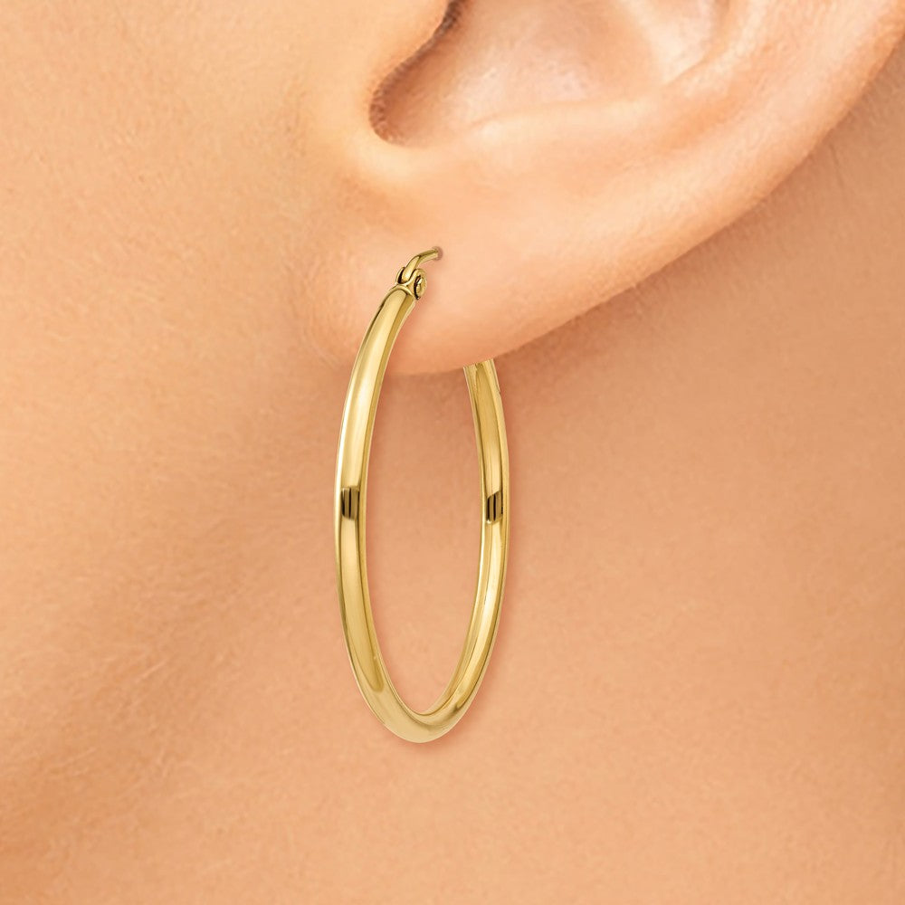 Alternate view of the 2mm x 30mm 14k Yellow Gold Classic Round Hoop Earrings by The Black Bow Jewelry Co.