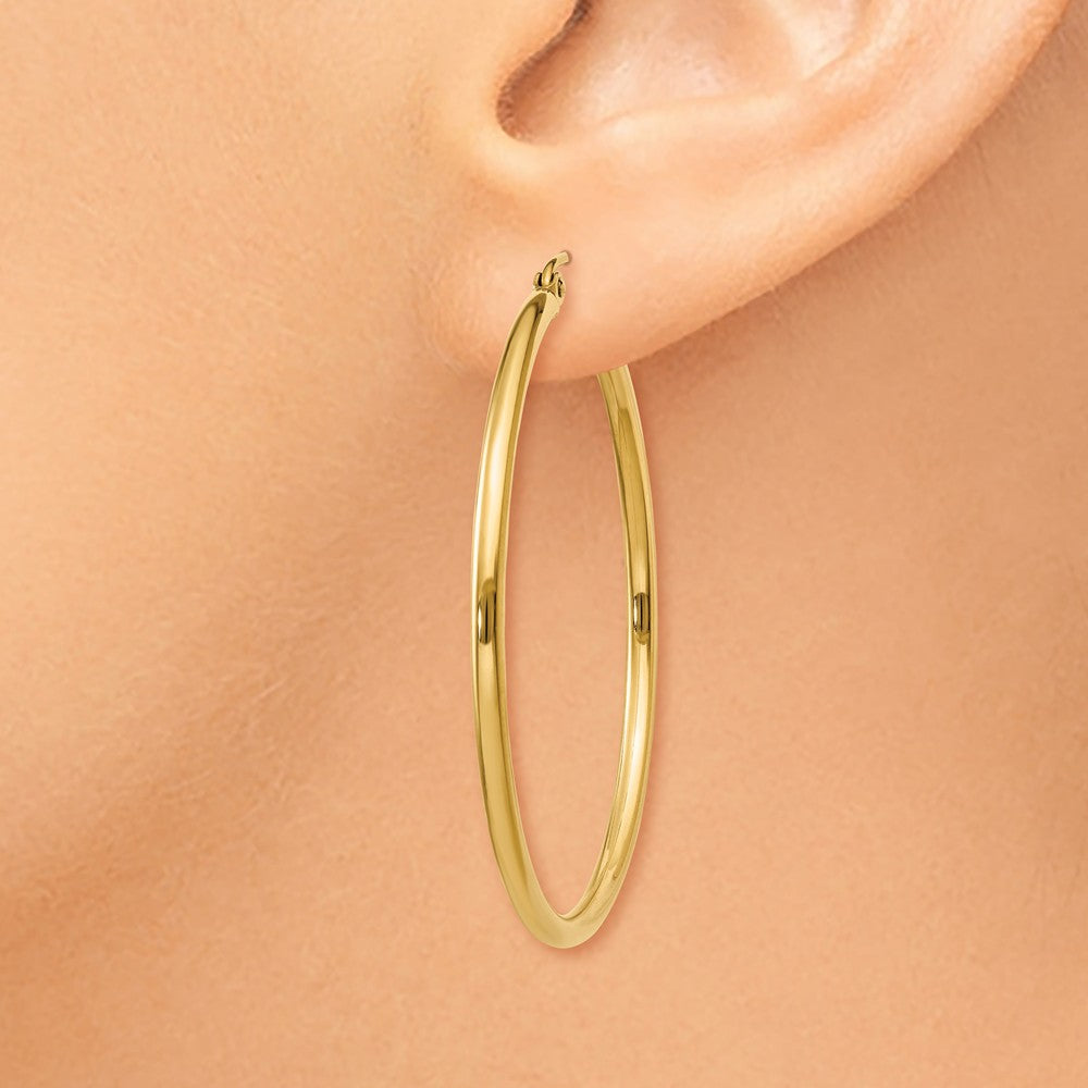 Alternate view of the 2mm x 40mm 14k Yellow Gold Classic Round Hoop Earrings by The Black Bow Jewelry Co.