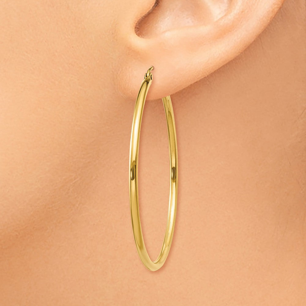 Alternate view of the 2mm x 45mm 14k Yellow Gold Classic Round Hoop Earrings by The Black Bow Jewelry Co.