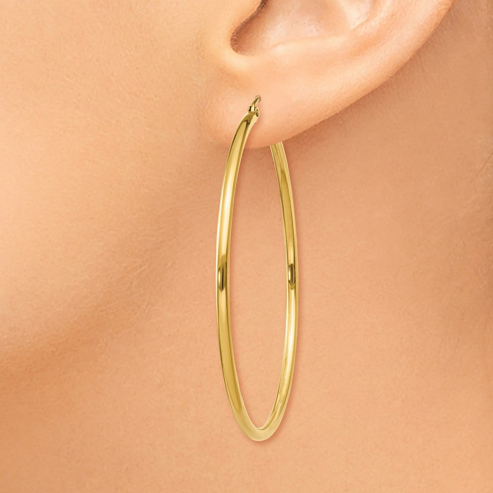 Alternate view of the 2mm x 50mm 14k Yellow Gold Classic Round Hoop Earrings by The Black Bow Jewelry Co.