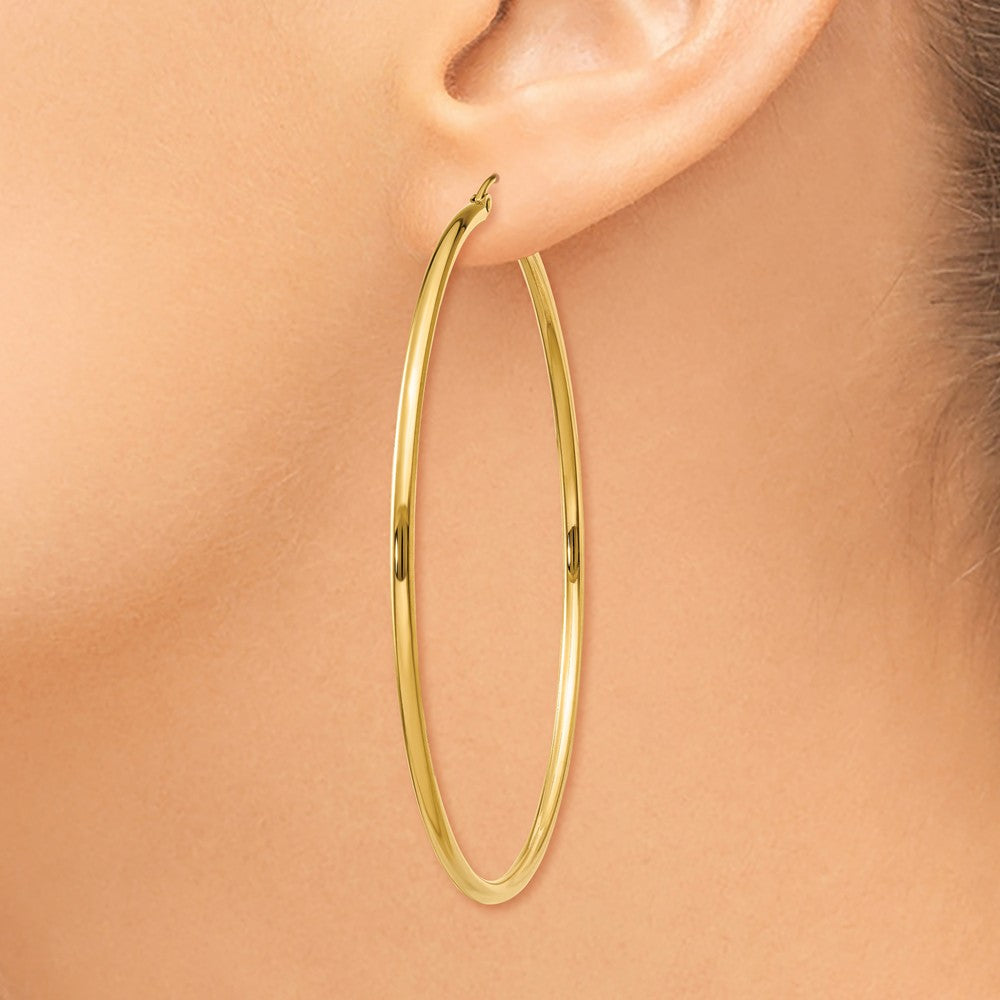 Alternate view of the 2mm x 60mm 14k Yellow Gold Classic Round Hoop Earrings by The Black Bow Jewelry Co.