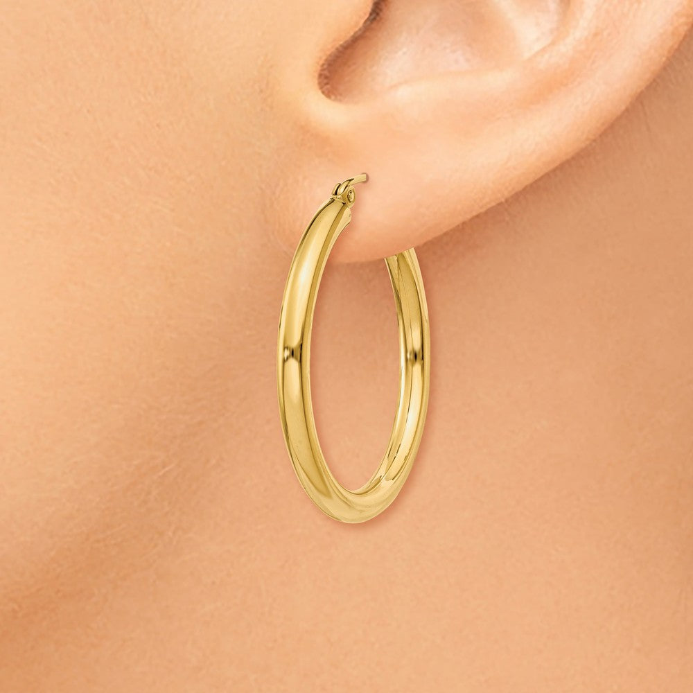 Alternate view of the 3mm x 30mm 14k Yellow Gold Classic Round Hoop Earrings by The Black Bow Jewelry Co.