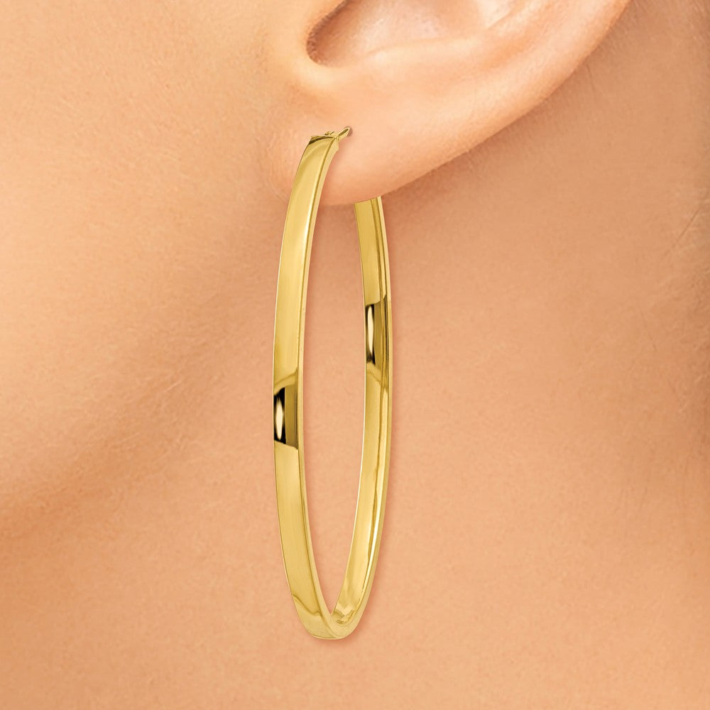 Alternate view of the 3mm x 54mm 14k Yellow Gold Polished Flat Tube Large Oval Hoop Earrings by The Black Bow Jewelry Co.