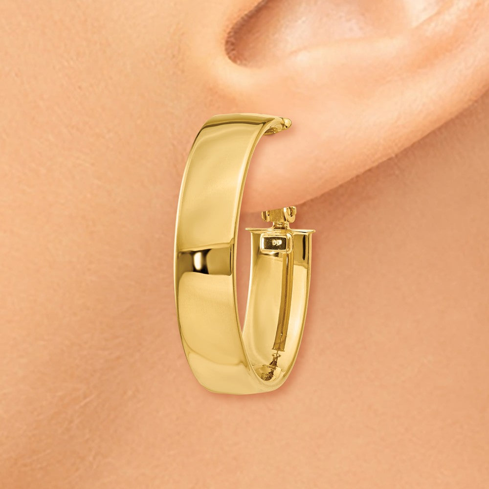Alternate view of the 6.75mm, 14k Yellow Gold Omega Back Oval Hoop Earrings, 25mm (1 Inch) by The Black Bow Jewelry Co.