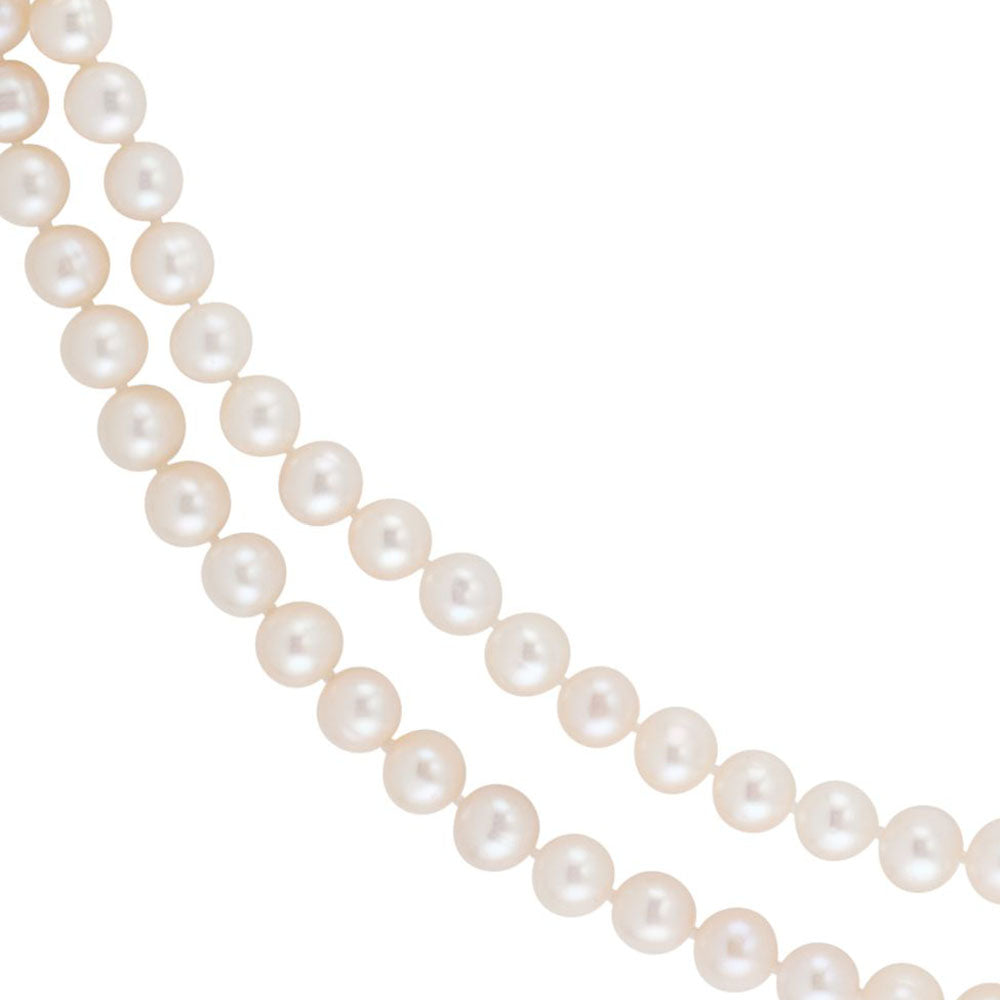 beautiful white pearls on background the dark blue silk, Stock image